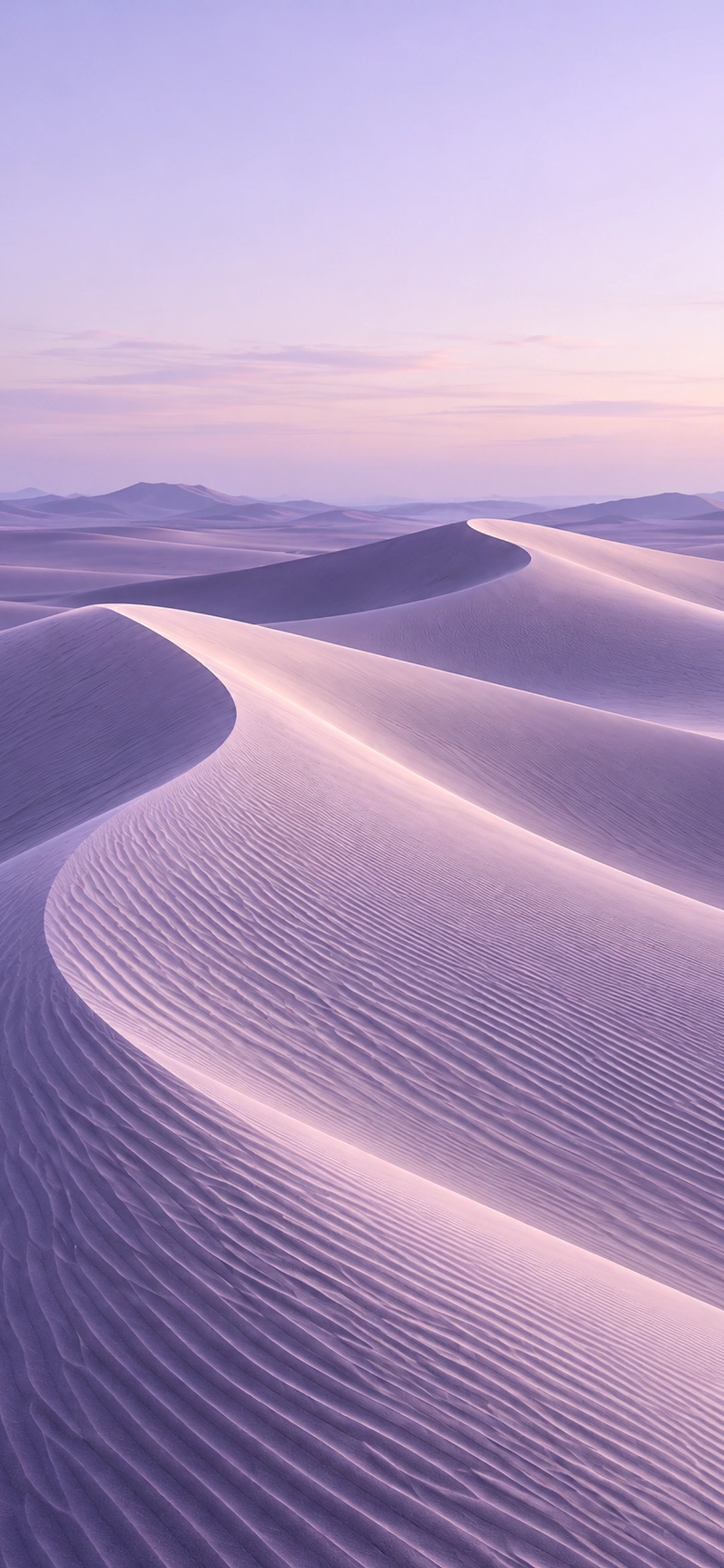 Soft violet sand ridges beneath a calm open horizon, light phone composition